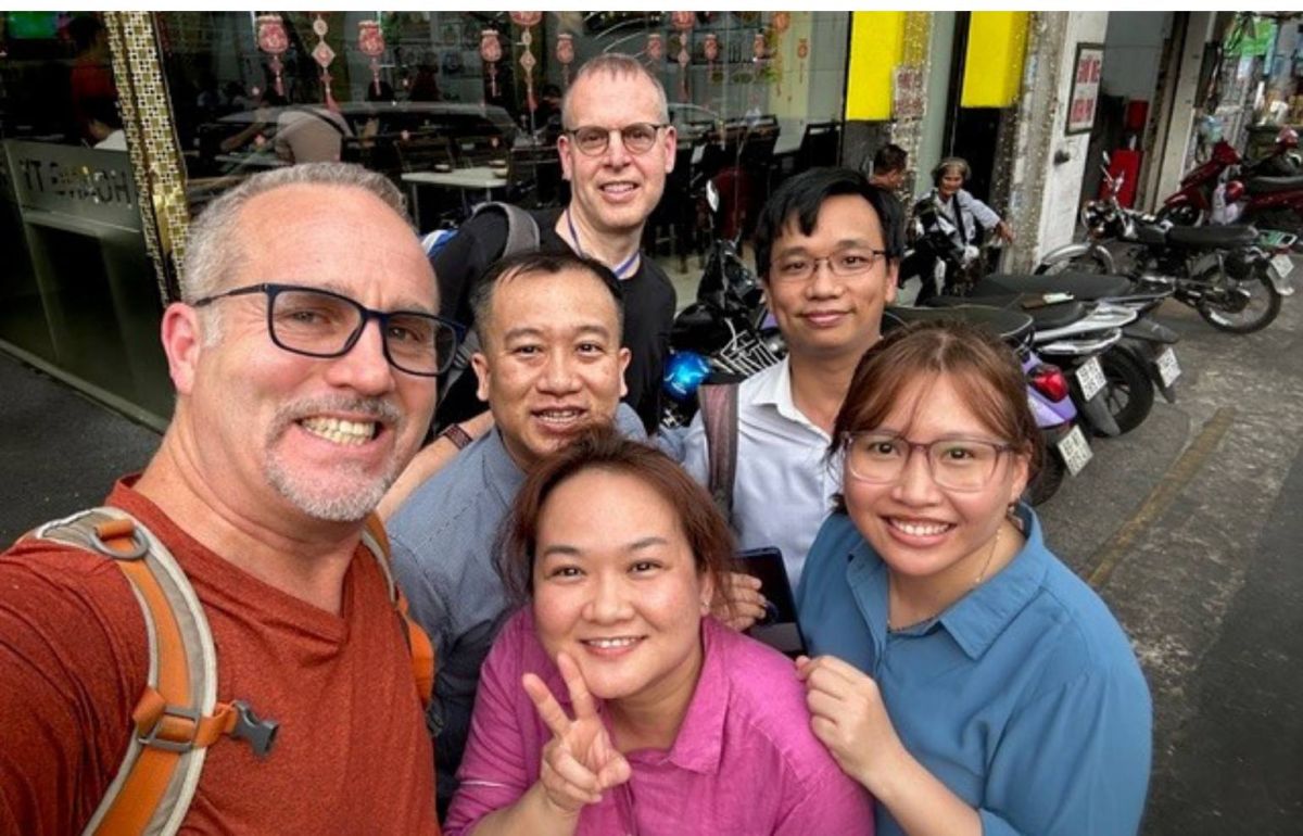 Dr. Vandersteen smiles with his medical colleagues on the streets of Vietnam.