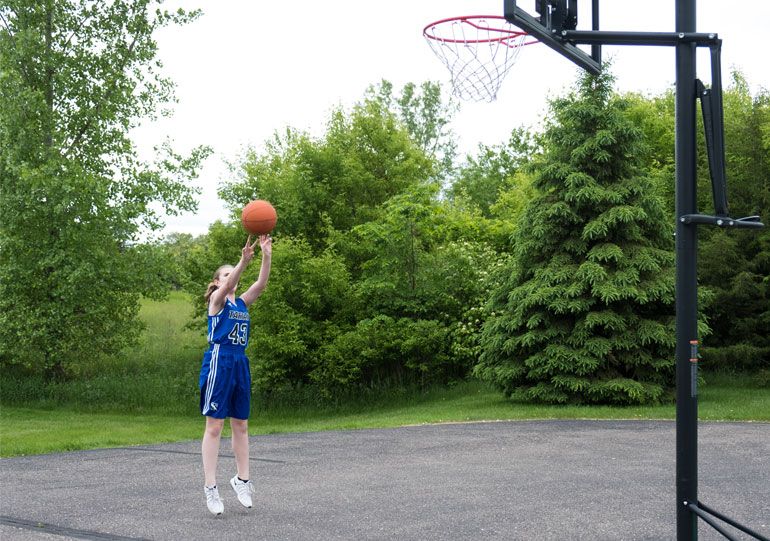 Erika is back to playing basketball after surgery to correct her scoliosis.