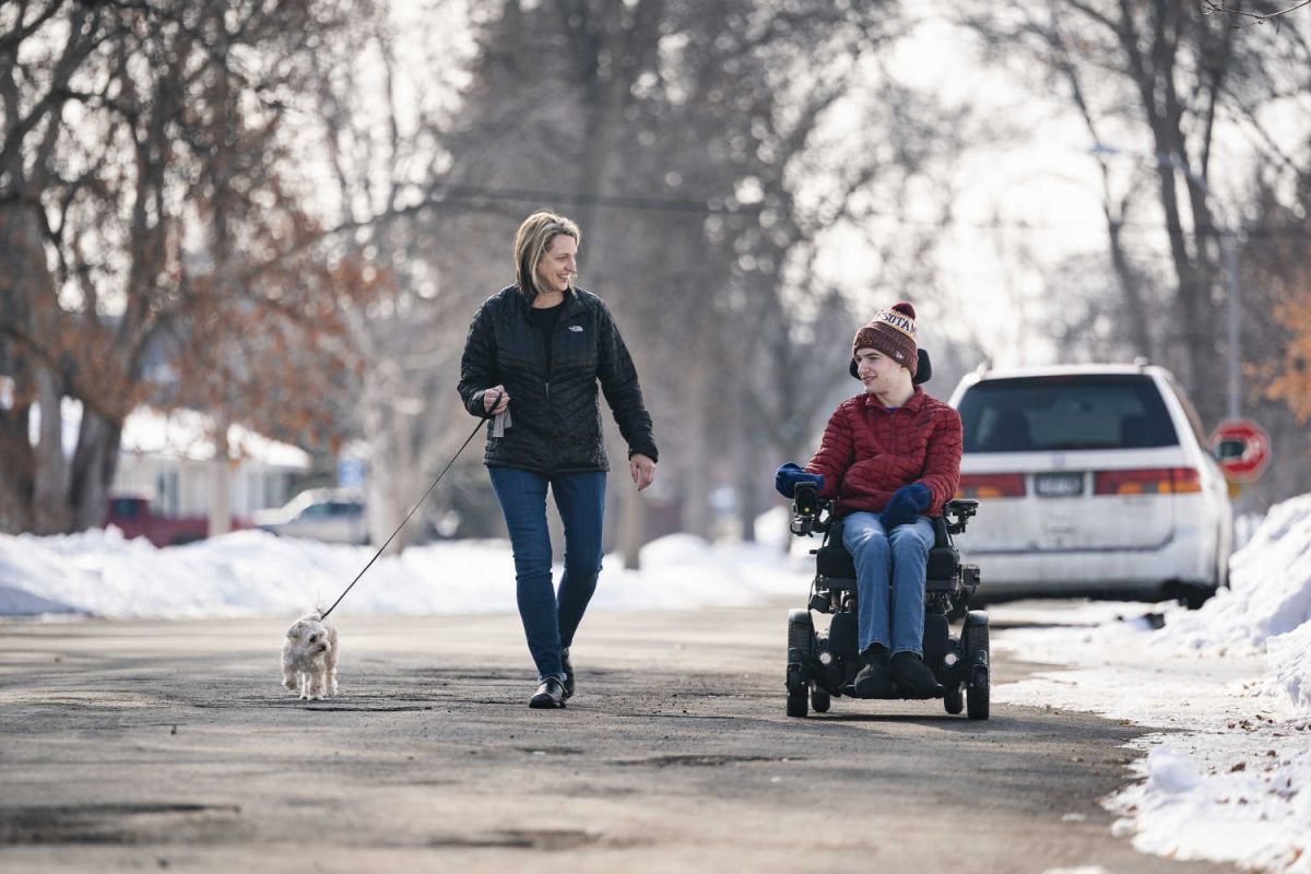 Joe and his mother, Kristi, take their dog Lucy for a walk. 