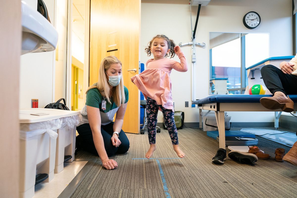 Rose Menke jumps during her appointment with a Gillette Children's physical therapist.