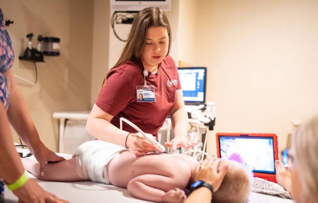 Pediatric spine specialist Danielle Harding, PA-C, adjusts a Gillette patient